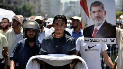 Egyptian supporters of deposed president Mohammed Morsi (on the poster) march during a demonstration against the government yesterday in Cairo.