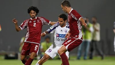 Al Ain's Ignacio Scocco, centre, tries to escape the attentions of Al Wahda's Yaqoob Al Hosani, left, and Magrao.