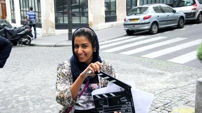 Shaqra Al Hameli, from Abu Dhabi clapping during the shooting of her short film in the streets of Paris. Courtesy PhotoHouse Digital Studio