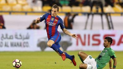 Barcelona’s Lucas Digne skips away from Al Ahli’s Housain Al-Mogahwi. Ibraheem Al Omari / Reuters