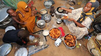An internally displaced Somali woman and her children prepare their Iftar meal during the month of Ramadan in Mogadishu, Somalia. Reuters