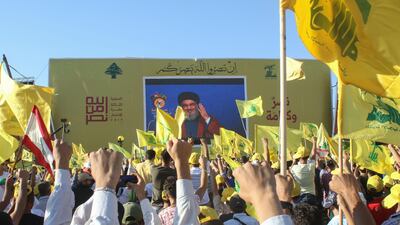 Supporters of Hezbollah wave the group's flag. AFP