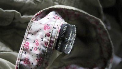 Walmart's Faded Glory label can be seen on a piece of clothing lying among equipment charred in the fire that killed 112 workers at the Tazreen Fashions factory, on the outskirts of Dhaka.