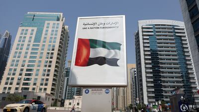 A poster in the marina reads 'UAE a Nation for Humanity'. Dubai Marina, Dubai. Chris Whiteoak / The National