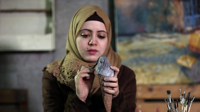 An artist makes a sculpture in the shape of a child in an ice cream cone in Rafah in the southern Gaza Strip. Reuters