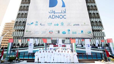 Above, officials and staff led by chief executive Sultan Al Jaber during Sunday’s unveiling of the Adnoc’s new branding. Courtesy of Adnoc