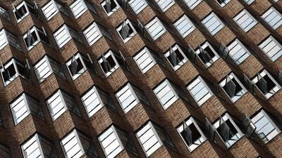 Windows are opened in a high rise building as mild spring weather arrives in Sydney. AFP