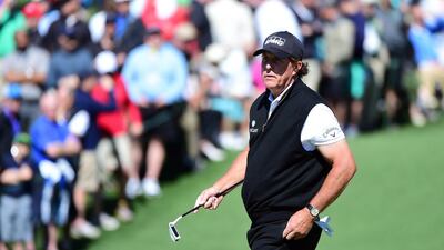 Phil Mickelson of the United States reacts after putting for par on the second green during the first round of the 2016 Masters Tournament at Augusta National Golf Club on April 7, 2016 in Augusta, Georgia. Harry How/Getty Images/AFP