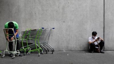A man wears a mask outside a supermarket in Manila. AP