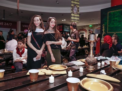 Black picnic tables set up at the entrance of Virgin Megastore mimic the Hogwarts Great Hall. Victor Besa / The National