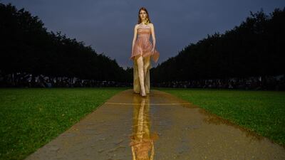 A model wears a sheer piece on the runway. AFP