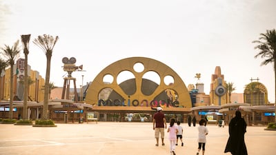 A family walks towards Motiongate park's entrance. Reem Mohammed / The National