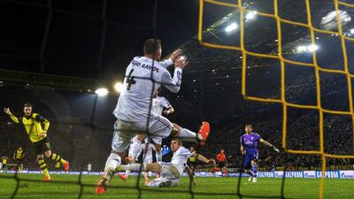 Borussia Dortmund striker Marco Reus scores during Tuesday night’s Champions League win over Real Madrid. Odd Andersen / AFP / April 8, 2014