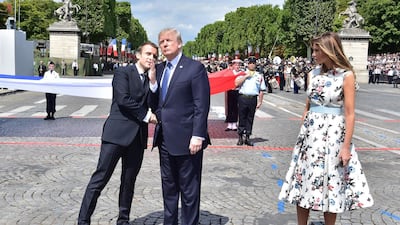 US President Donald Trump and First Lady Melania Trump are seen here with French President Emmanuel Macron during the annual Bastille Day military parade on the Champs-Elysees avenue in Paris on July 14, 2017. Christophe Archambault / AFP