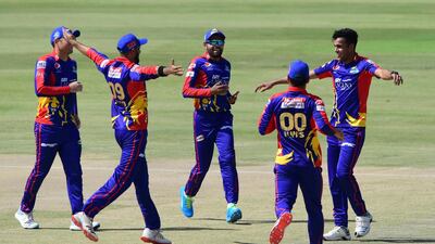 Karachi Kings' Abbas Afridi celebrates with teammates the wicket of Peshawar Zalmi's Tom Kohler-Cadmore at the National Stadium in Karachi on March 3, 2021.