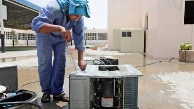 Air conditioners are cleaned at Al Arqam school. Lee Hoagland / The National