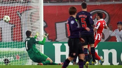 Olympiakos' Giannis Maniatis scores against Arsenal during their Champions League clash.
