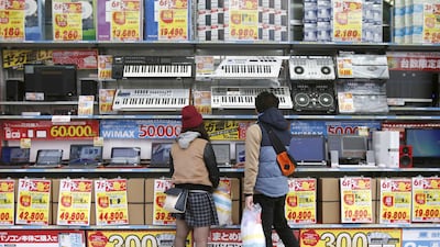 People try out laptops displayed at an electronics retail store in Tokyo on November, 16, 2014. Yuya Shino / Reuters