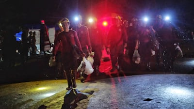 Military personnels, rescue workers and volunteers head out from Tham Luang Nang Non cave. Getty Images