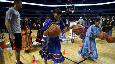 Francisco Garcia, left, of the Houston Rockets conducts a drill with players from the Tarahumara women's basketball team on Tuesday in Mexico City. Yuri Cortez / AFP