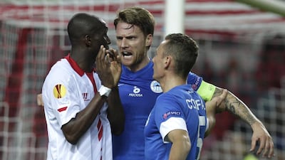 Sevilla’s Stephane Mbia, left, and Paulo of Real Betis were victims of racist chants last week. Toni Rodriguez / AP Photo