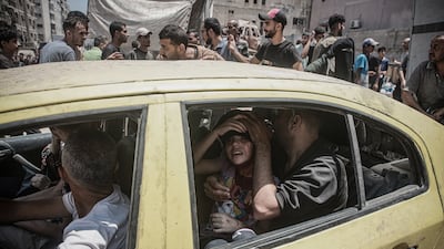 Injured Palestinian children are moved to safe places after an Israeli air strike in the Gaza Strip on July 25. All photos: Abdalhkem Abu Riash / Anadolu via Getty images