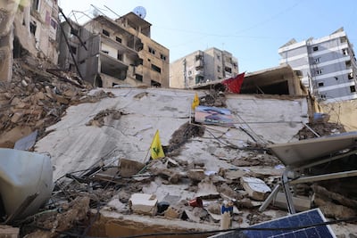 Yellow flags of Hezbollah are stuck on a building destroyed in recent Israeli bombardment in southern Beirut. AFP