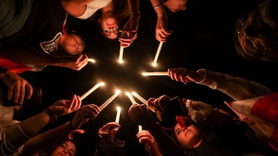Lebanese protesters light up candles during a vigil at a demonstration in the southern Lebanese city of Sidon on the tenth day of country-wide protests against tax increases and official corruption. AFP
