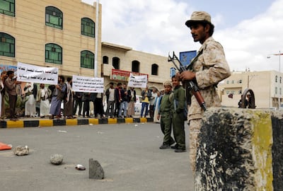 A Yemeni soldier keeps watch as members of the Bahai faith members protest against the trial of Hamed Haydara in Sanaa. EPA