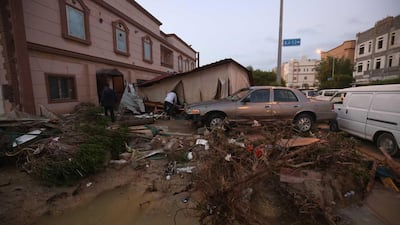 People check the damage in a residential area following heavy rain in the al-Fahahil district, south of Kuwait City. AFP