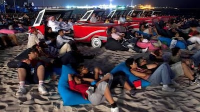 Visitors to the FanZone watch the movie Knight Rider last night on the Corniche during the Cinema by the Sea event, part of Yasalam in Abu Dhabi.