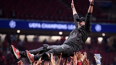 Klopp is thrown in the air as he celebrates with his players and staff. Getty