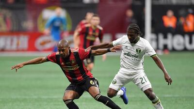 Atlanta United's Darlington Nagbe holds off Portland Timbers' Diego Chara. Reuters