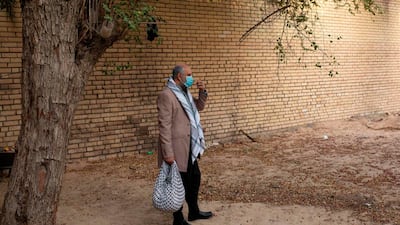 Iraqi actor Mohammad Qassem, the main character of a parody sketch video of Bab al-Hara, an adaptation of an iconic long-running Syrian television drama, wears a face mask while acting on set in Iraq's southern port city of Basra on April 22, 2020. AFP / Hussein Faleh