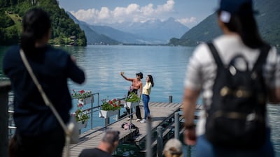 Tourists take a selfie on the pier by Lake Brienz