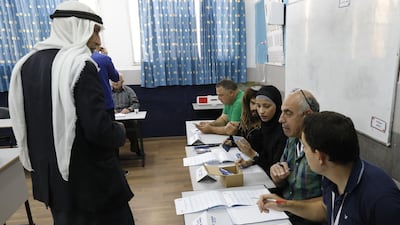 An Arab Israeli man registers before voting in Israel's parliamentary elections. AFP