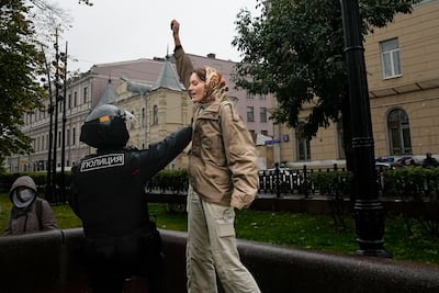 A police officer detains a demonstrator during a protest against a partial mobilisation in Moscow, Russia. AP
