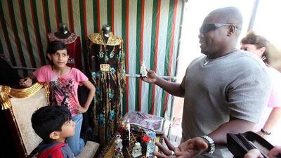 Jacob Albeajali negotiates a price at a stall in Khalifa Park yesterday at the start of the Community Market.