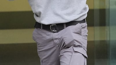 Mr Trickett covering his face as he leaves Westminster Magistrates' Court, central London on May 13. PA