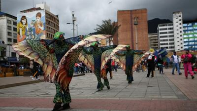 Actors dressed as hummingbirds perform on the streets, flapping their wings during a mayoral campaign to promote social distancing, in Bogota, Colombia. Reuters