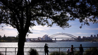 Tourists take photographs as they stand in front of the Sydney Harbour Bridge and Sydney Opera House in Australia, November 13, 2018. REUTERS/David Gray