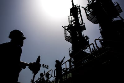 Workers transfer liquefied natural gas between ships in Karachi, Pakistan. Bloomberg