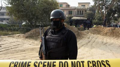 Armed police guard the cordoned-off crime scene. Reuters