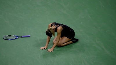 Maria Sharapova collapses to the court after deating Simona Halep. Julio Cortez / AP Photo