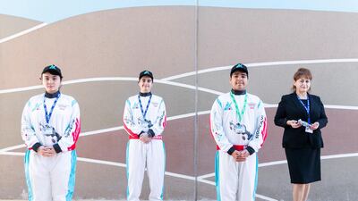 The fledgling F1 crew members, Aisyah Torbett, Alexander Ghorayeb and Arnav Kedia with their school teacher Florentina Niculae-Evans