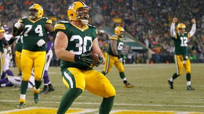Green Bay's John Kuhn celebrates his touchdown against the Minnesota Vikings.