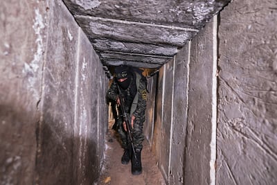 A member of the Palestinian Islamic Jihad militant group walks in a tunnel in the Gaza strip, on April 17, 2022, during a media tour. AFP