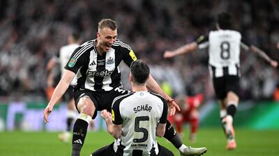 Newcastle defenders Dan Burn and Fabian Schar celebrate after the final whistle at Wembley. Getty Images