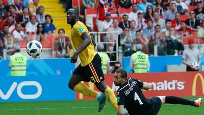 Belgium's Romelu Lukaku, left, scores his second and Belgium's third goal past Tunisia goalkeeper Farouk Ben Mustapha in a 5-2 win at Spartak Stadium in Moscow. Hassan Ammar / AP Photo