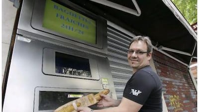 French baker Jean-Louis Hecht shows off his instant baguette dispenser in Paris this week. He says his 24-hour automated dispenser offers warm, fresh bread to hungry night owls, graveyard shift workers and those who missed his regular opening hours.